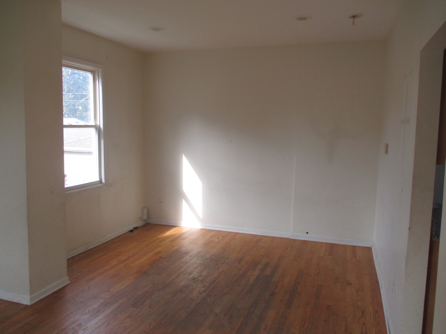 1324 Clinton Avenue Berwyn, IL 60402 - Photo 2 of 14 an empty room with wooden floor and windows
