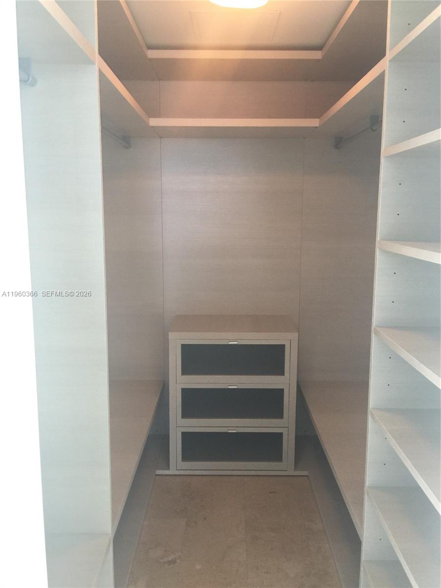 68 Southeast 6th Street, Unit 3412 Miami, FL 33131 - Photo 13 of 13 a view of walk in closet with empty racks