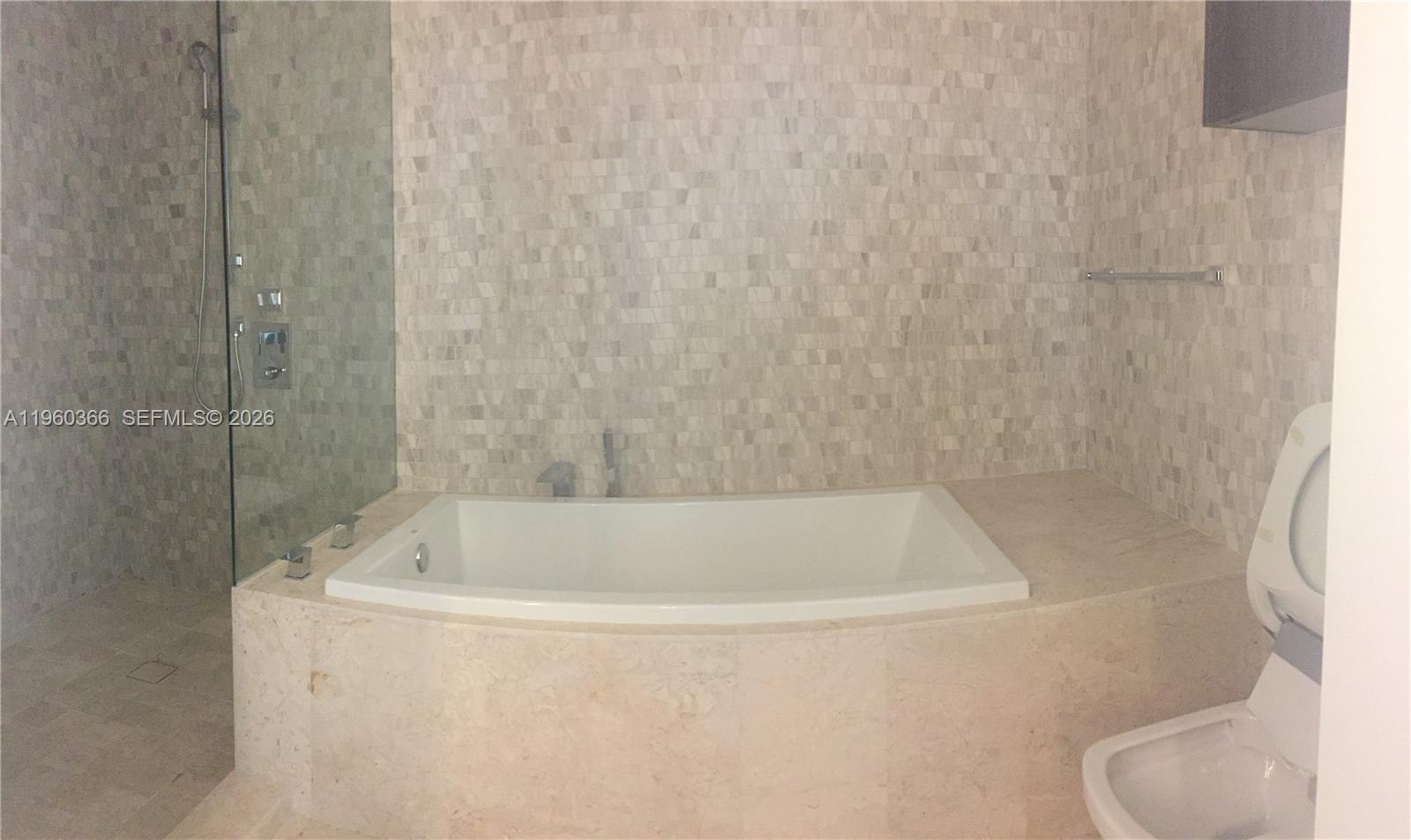 68 Southeast 6th Street, Unit 3412 Miami, FL 33131 - Photo 2 of 13 a bath tub sitting next to a white toilet