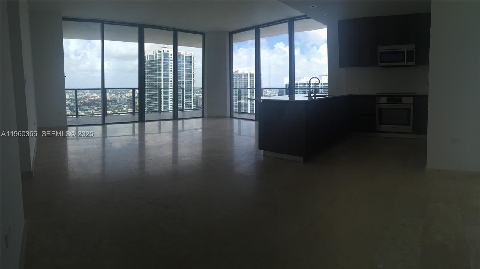 68 Southeast 6th Street, Unit 3412 Miami, FL 33131 - Photo 4 of 13 a living room with hardwood floor and large windows