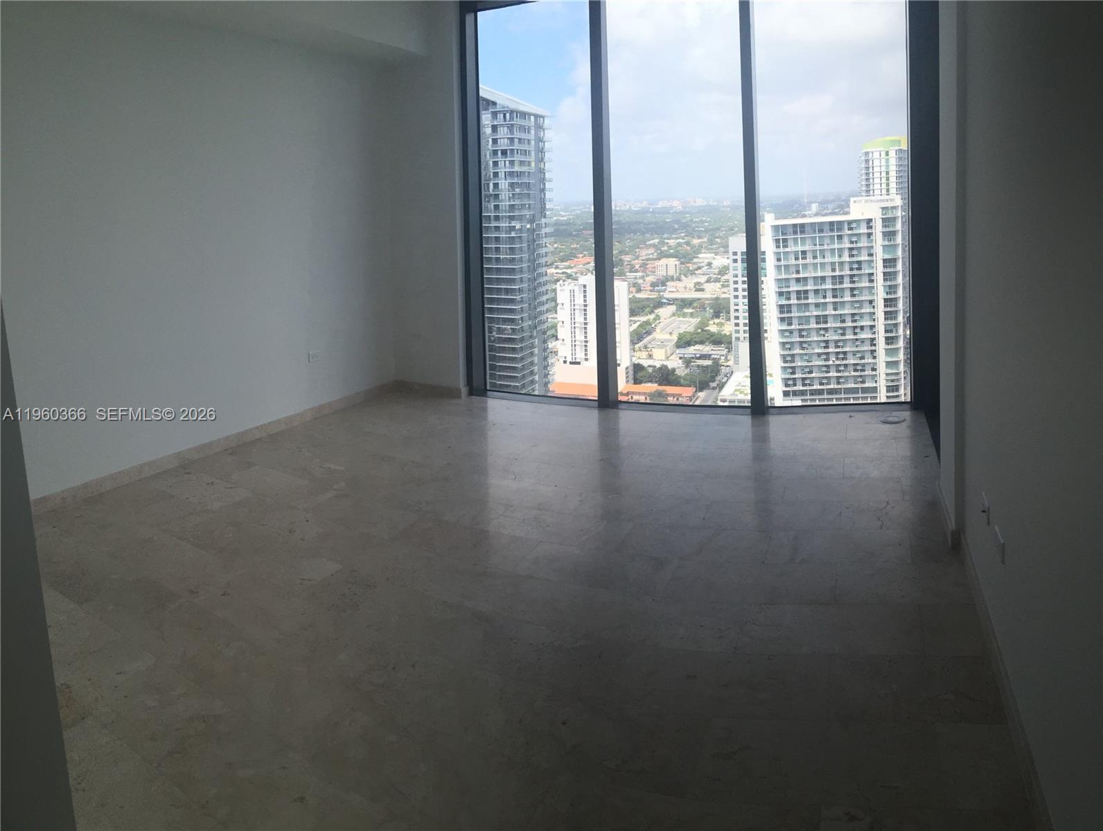 68 Southeast 6th Street, Unit 3412 Miami, FL 33131 - Photo 5 of 13 a view of an empty room with windows