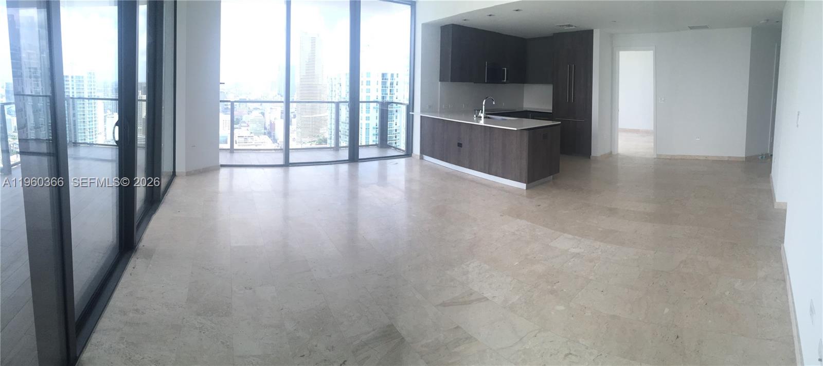 68 Southeast 6th Street, Unit 3412 Miami, FL 33131 - Photo 9 of 13 a kitchen with stainless steel appliances granite countertop a stove top oven a sink and a refrigerator with wooden floor