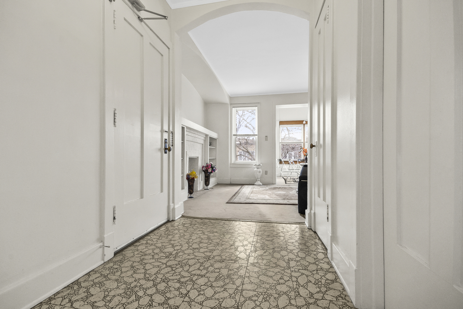 1244 West Arthur Avenue, Unit 2 Chicago, IL 60626 - Photo 2 of 25 a hall way with to a window and a hallway