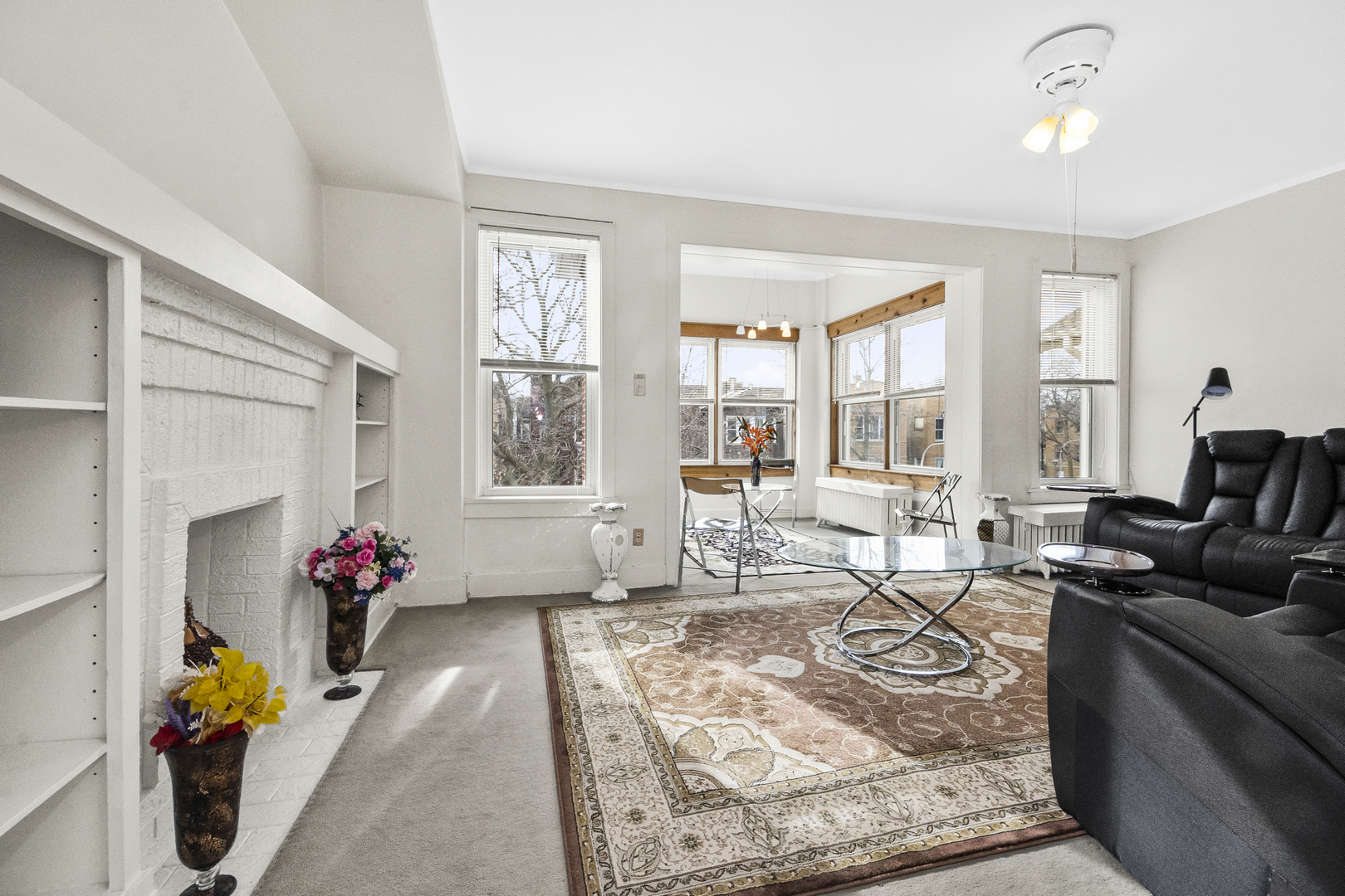 1244 West Arthur Avenue, Unit 2 Chicago, IL 60626 - Photo 3 of 25 a living room with furniture flowers and a window
