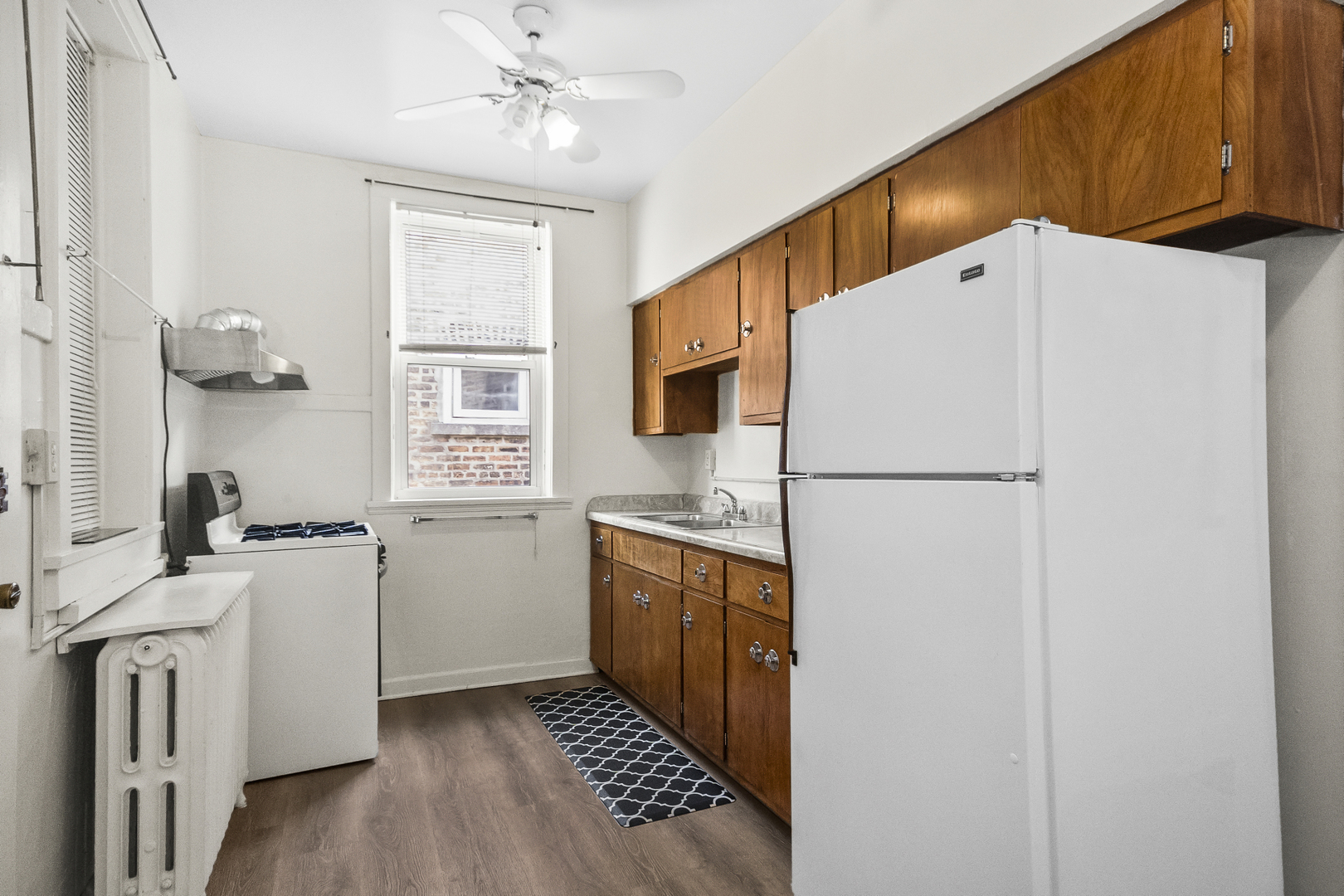 1244 West Arthur Avenue, Unit 2 Chicago, IL 60626 - Photo 9 of 25 a kitchen with stainless steel appliances a refrigerator sink and stove