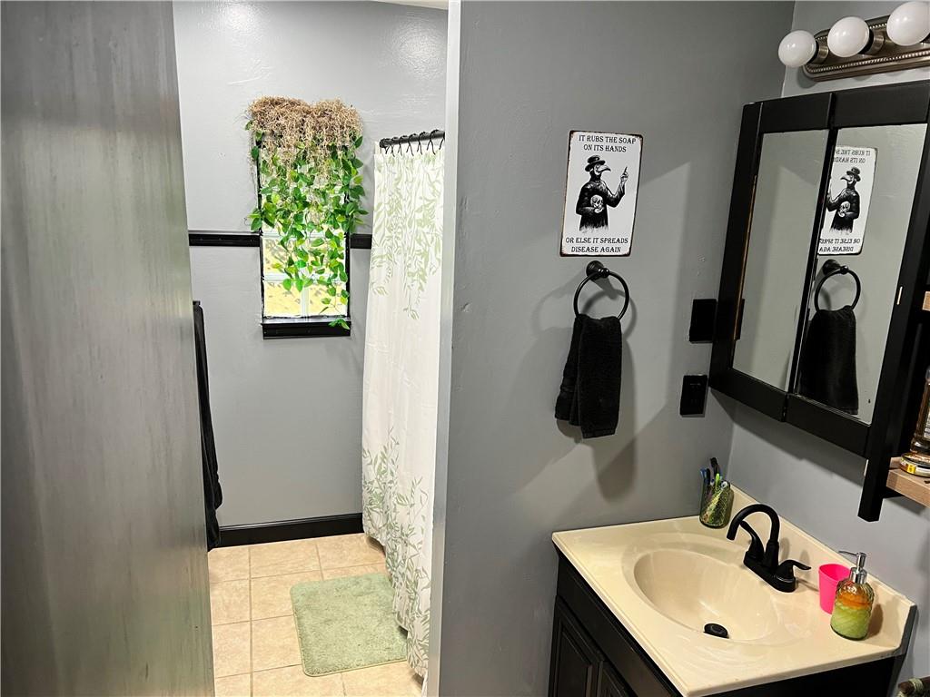 303 Leech Road Greenville, PA 16125 - Photo 13 of 16 a bathroom with a sink and a mirror