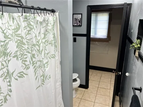 a bathroom with a shower and a sink