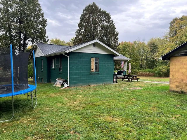 a backyard of a house with table and chairs