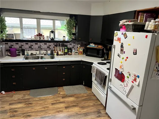 a kitchen with a sink stove and refrigerator