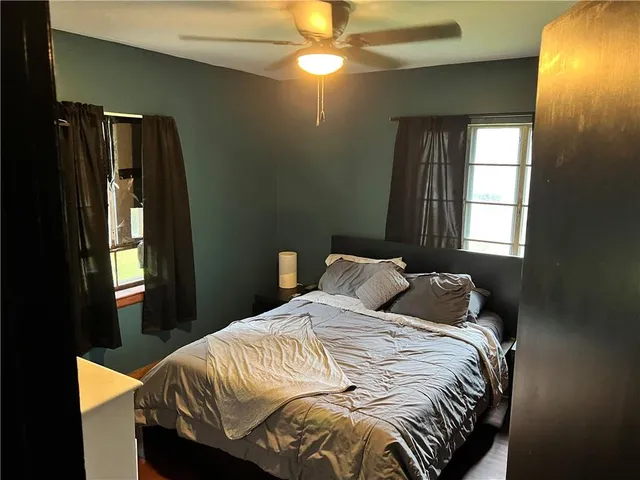 a bedroom with a bed and a mirror