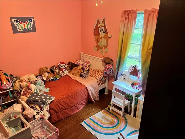 a bed room with a bed and a chair