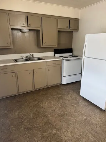 a kitchen with cabinets and white appliances