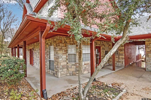 a view of a house with a small yard and wooden fence