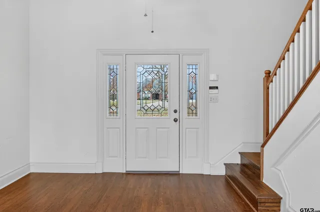 a view of an entryway with wooden floor