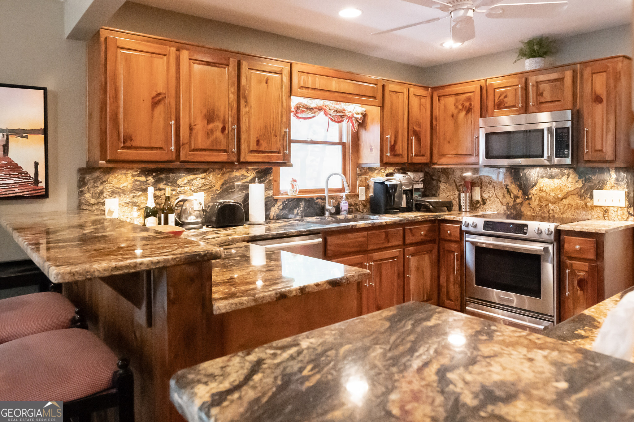455 Chase Landing Martin, GA 30557 - Photo 13 of 37 a kitchen with stainless steel appliances granite countertop a stove sink microwave and cabinets