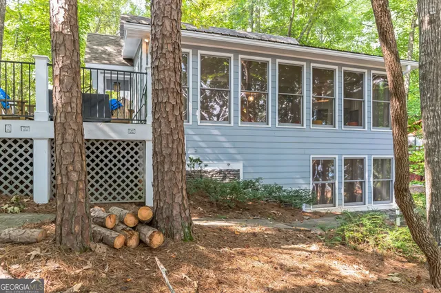 a view of a house with backyard and sitting area