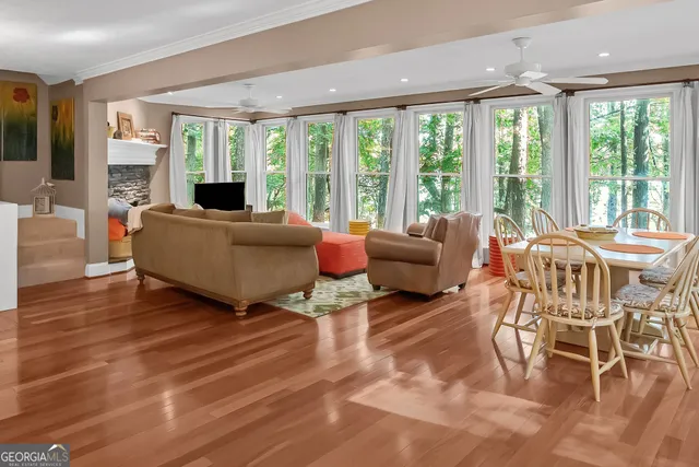 a living room with furniture and large windows