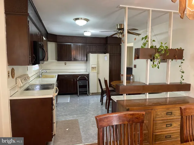 a kitchen with a sink appliances and cabinets
