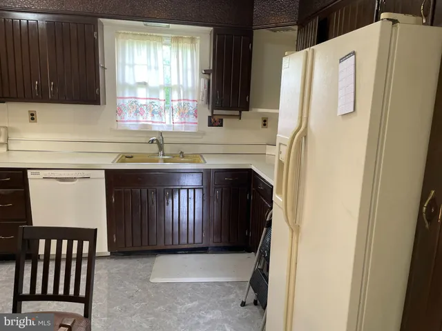 a kitchen with a refrigerator and a sink