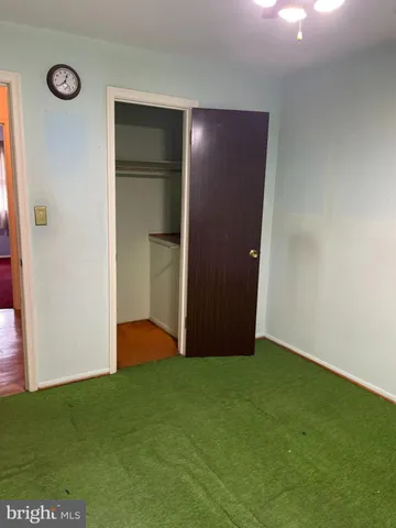 a view of an empty room with closet and entertaining space