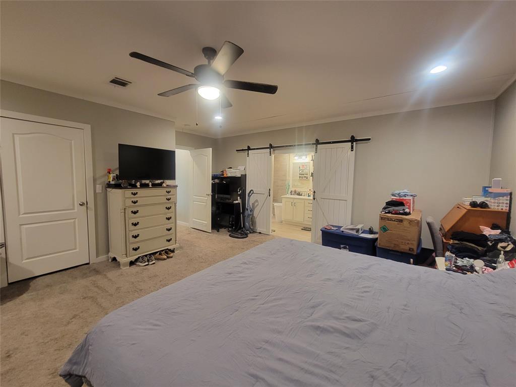 150 Hawkins Chapel Road Loving, TX 76460 - Photo 17 of 40 a bed room with furniture and a flat screen tv