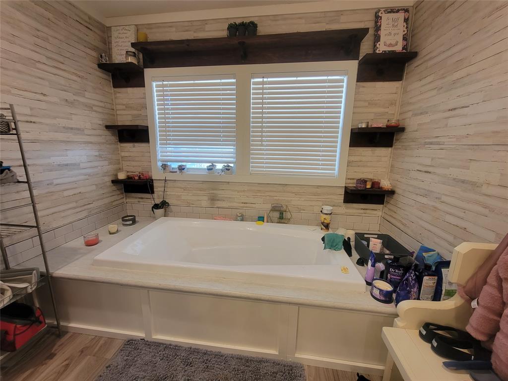 150 Hawkins Chapel Road Loving, TX 76460 - Photo 19 of 40 a bathroom with a bathtub and a window
