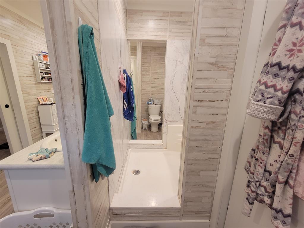 150 Hawkins Chapel Road Loving, TX 76460 - Photo 22 of 40 a bathroom with a sink and mirror with bathtub