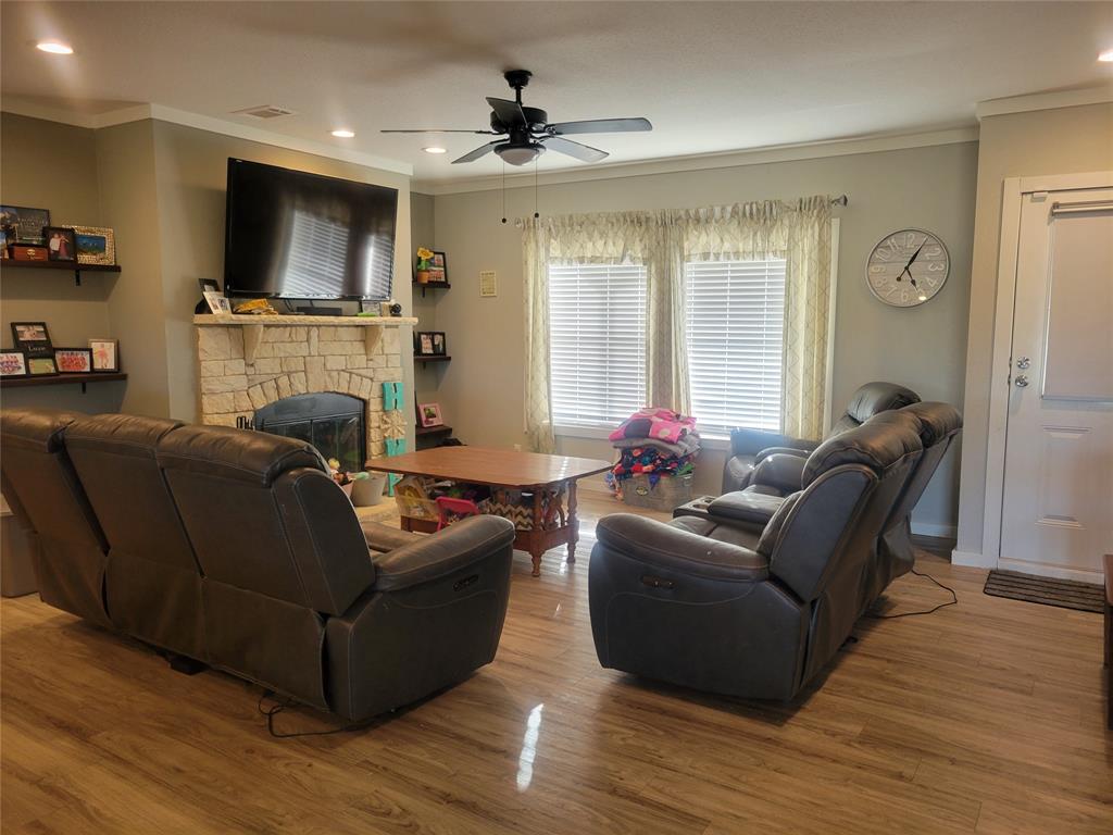 150 Hawkins Chapel Road Loving, TX 76460 - Photo 24 of 40 a living room with furniture a flat screen tv and a fireplace
