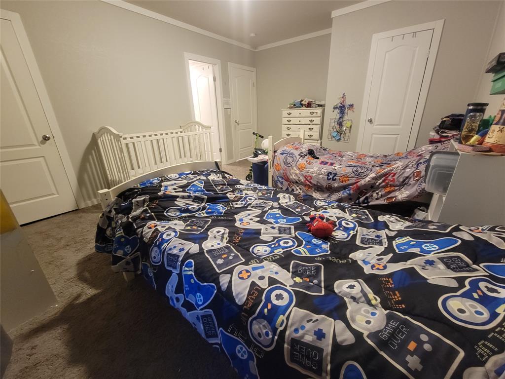 150 Hawkins Chapel Road Loving, TX 76460 - Photo 36 of 40 a bed sitting in a bedroom next to a window