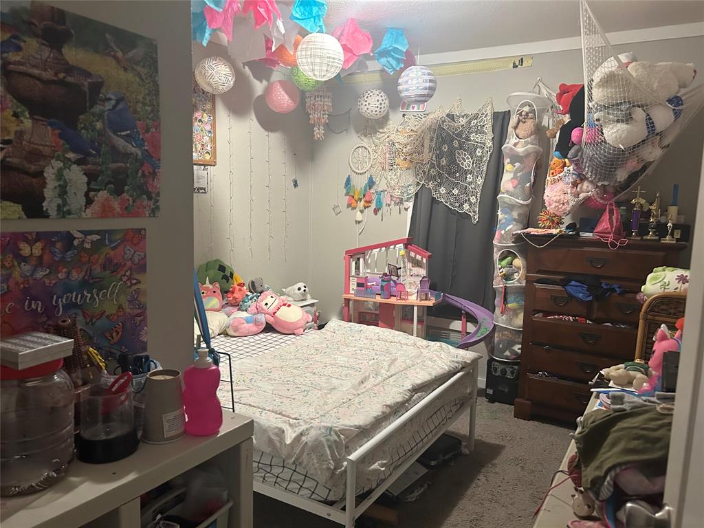 150 Hawkins Chapel Road Loving, TX 76460 - Photo 37 of 40 a bedroom with a bed and dresser