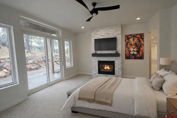 a bedroom with a large bed and a fireplace