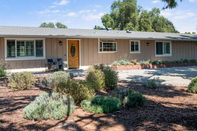 a front view of a house with garden