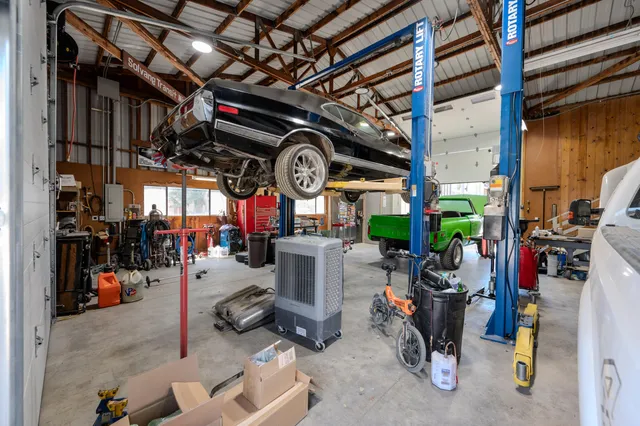 an aerial view of a house with a yard and lake view