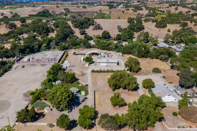 an aerial view of a house with yard