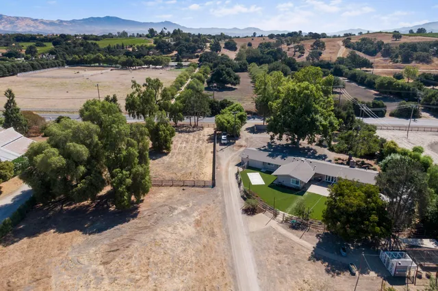 an aerial view of a city with lots of residential buildings and mountain view in back
