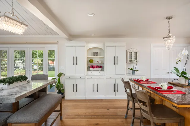 a living room with kitchen island furniture and a chandelier