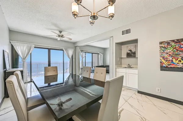 a living room with furniture a flat screen tv and a table