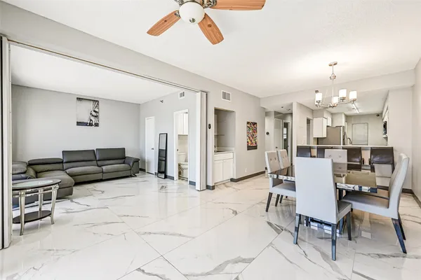 a living room with lots of furniture and a chandelier
