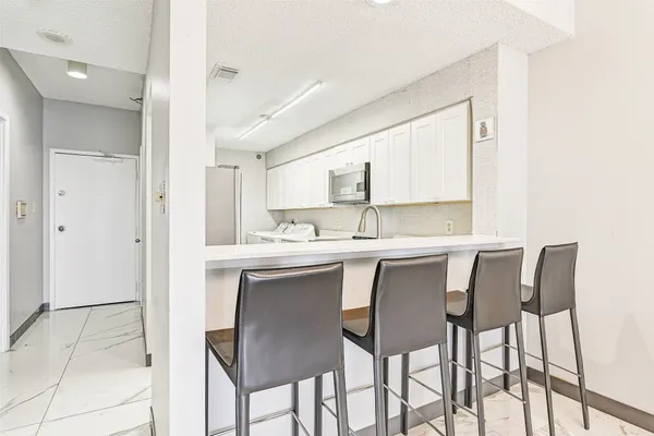 a dining room with chairs and window