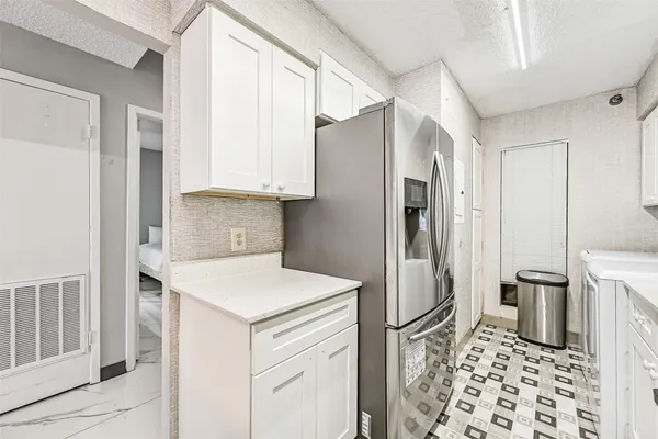a kitchen with a refrigerator and a sink