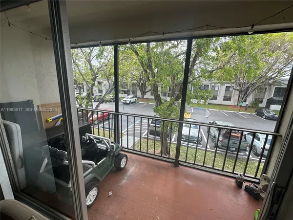 a view of a balcony with chair and floor to ceiling window