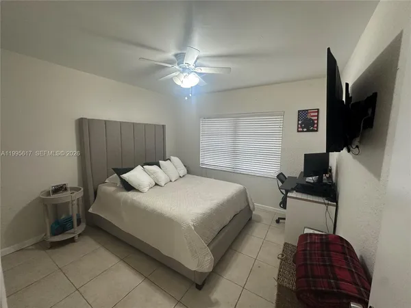 a bedroom with a bed and a flat screen tv