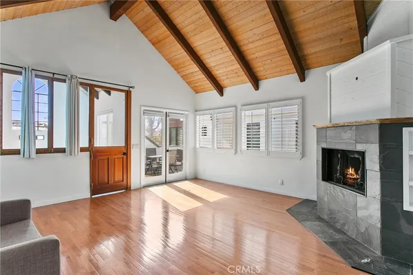 a view of an empty room with a fireplace and a window