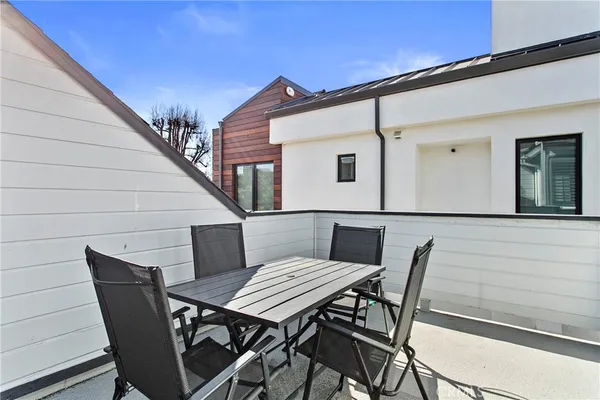 a view of a patio with table and chairs