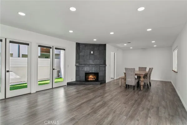 a view of a livingroom with furniture fireplace and wooden floor