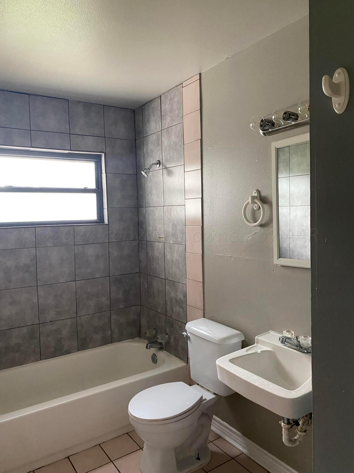 1010 Ricks Street Amarillo, TX 79104 - Photo 7 of 8 a bathroom with a sink toilet and shower