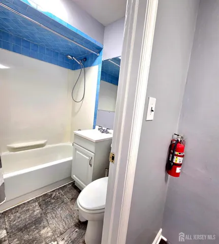 a bathroom with a toilet sink and tub