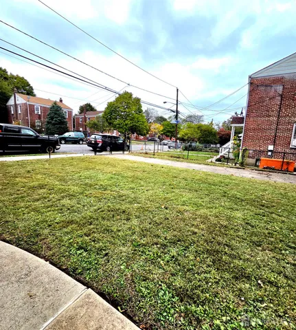 a view of a house with a yard and sitting area
