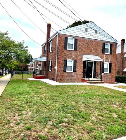 a kitchen with a checkered floor and white cabinets