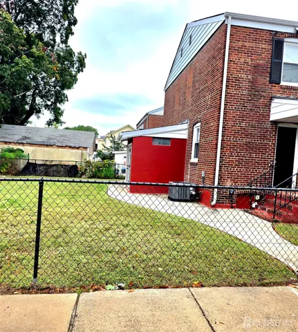a view of a brick house with a yard